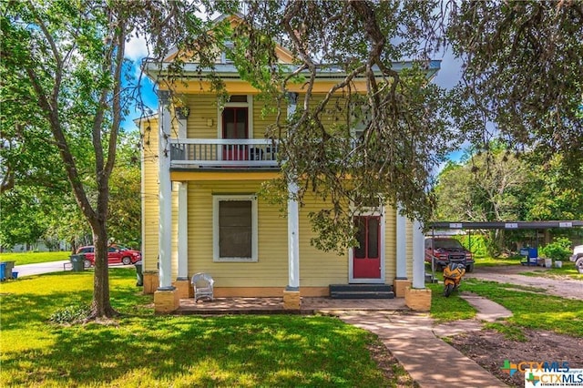311 E Live Oak St, Seguin, TX 78155 - view of front facade featuring entry steps, a balcony, and a front yard
