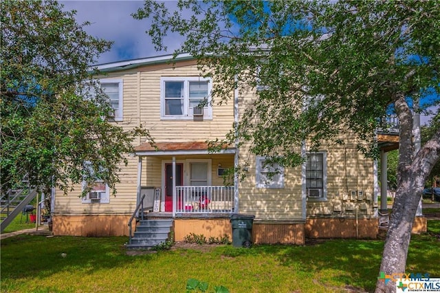 view of front of house with a front yard and covered porch