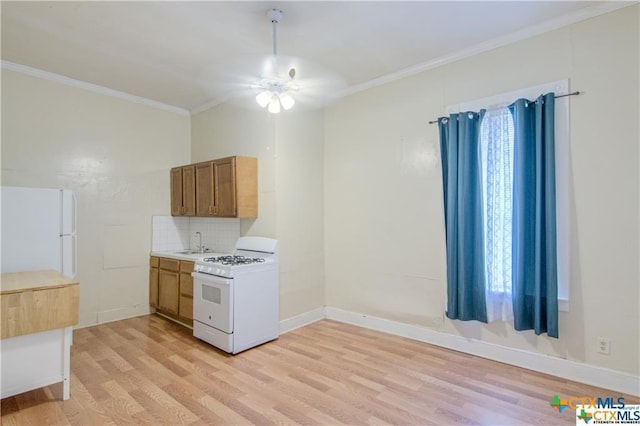 kitchen featuring white appliances, decorative backsplash, light wood-type flooring, ceiling fan, and sink