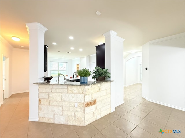 3312 Vineyard Trl, Harker Heights, TX 76548 - kitchen featuring light tile patterned floors, stone counters, decorative columns, recessed lighting, and a peninsula