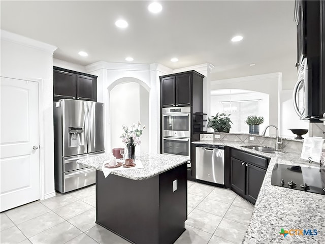 3312 Vineyard Trl, Harker Heights, TX 76548 - kitchen with stainless steel appliances, arched walkways, ornamental molding, light tile patterned floors, and light stone counters