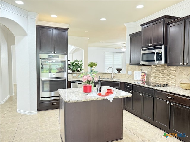 3312 Vineyard Trl, Harker Heights, TX 76548 - kitchen with stainless steel appliances, backsplash, light stone countertops, light tile patterned flooring, and ornamental molding
