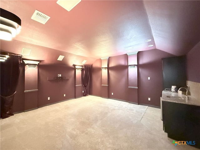 3312 Vineyard Trl, Harker Heights, TX 76548 - carpeted home theater room featuring vaulted ceiling and a textured ceiling