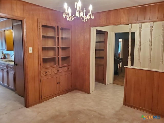 18581 State Highway 53, Temple, TX 76501 - unfurnished dining area featuring a chandelier, light flooring, and wooden walls