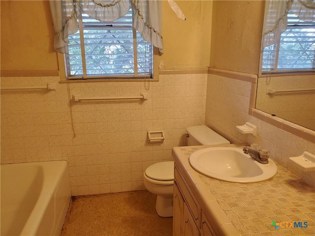 18581 State Highway 53, Temple, TX 76501 - bathroom with tile walls, a tub to relax in, vanity, and wainscoting