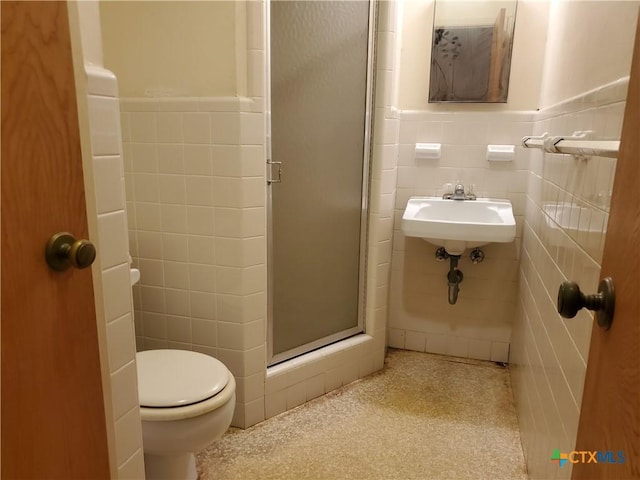 18581 State Highway 53, Temple, TX 76501 - full bathroom featuring tile walls, a stall shower, and a wainscoted wall
