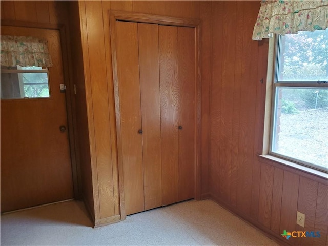 18581 State Highway 53, Temple, TX 76501 - unfurnished bedroom featuring wooden walls, a closet, and multiple windows