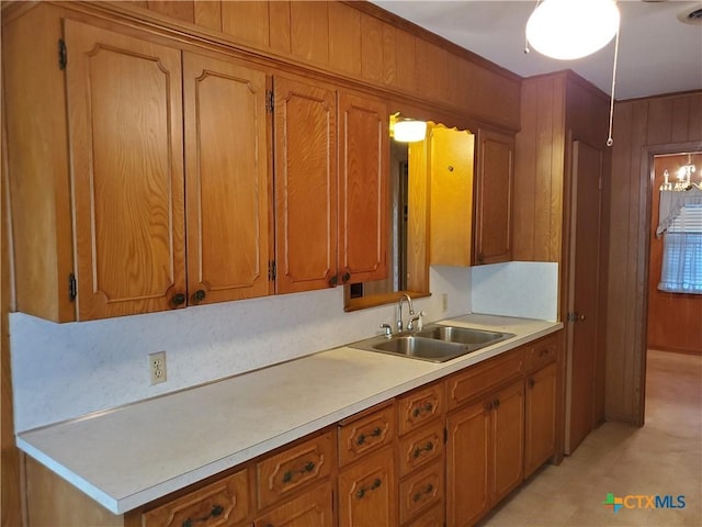 18581 State Highway 53, Temple, TX 76501 - kitchen with light countertops, brown cabinetry, and wooden walls
