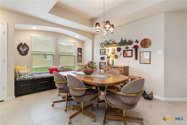 dining area featuring baseboards, light tile patterned floors, and a chandelier