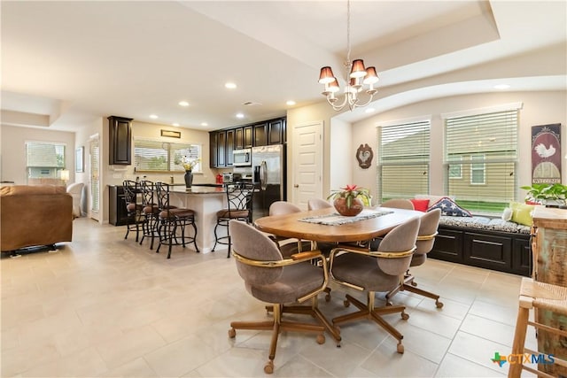 dining room with recessed lighting, an inviting chandelier, plenty of natural light, and light tile patterned flooring