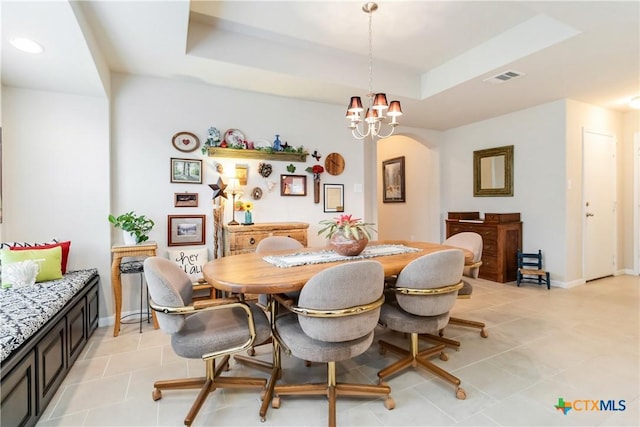 dining area with an inviting chandelier, arched walkways, light tile patterned flooring, and visible vents