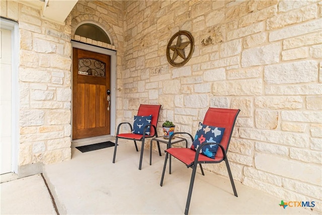 view of exterior entry featuring stone siding