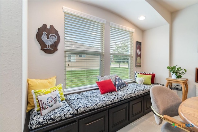 sitting room with light tile patterned floors, recessed lighting, and lofted ceiling