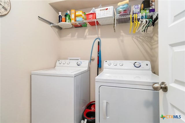 laundry room featuring separate washer and dryer and laundry area