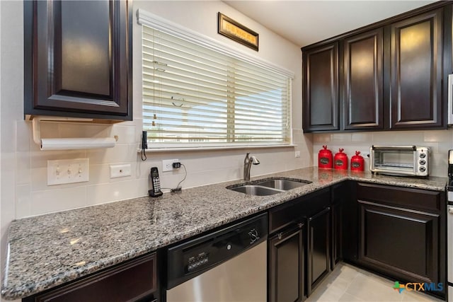kitchen with stainless steel dishwasher, a toaster, stone countertops, tasteful backsplash, and a sink