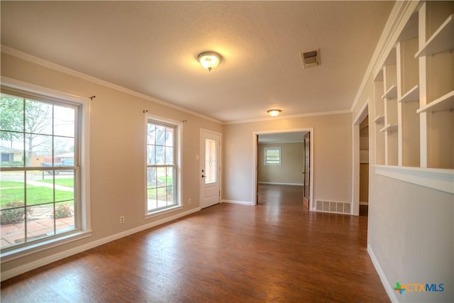 interior space featuring crown molding, a healthy amount of sunlight, dark hardwood / wood-style flooring, and a textured ceiling