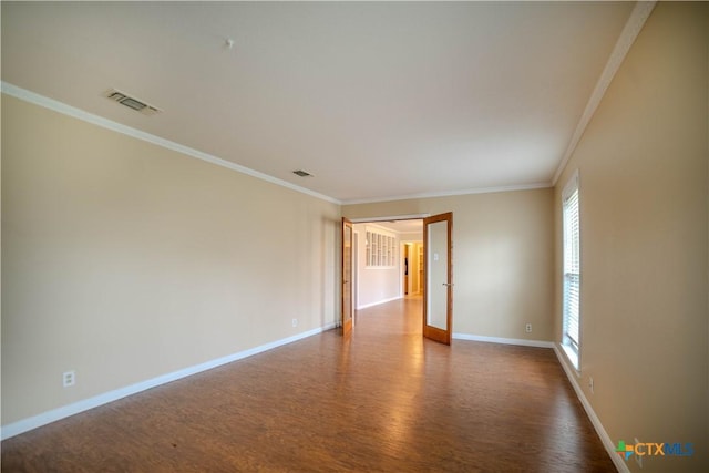 empty room featuring ornamental molding and dark hardwood / wood-style floors