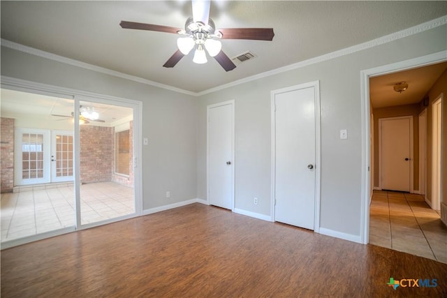 unfurnished bedroom featuring french doors, ceiling fan, ornamental molding, and hardwood / wood-style floors