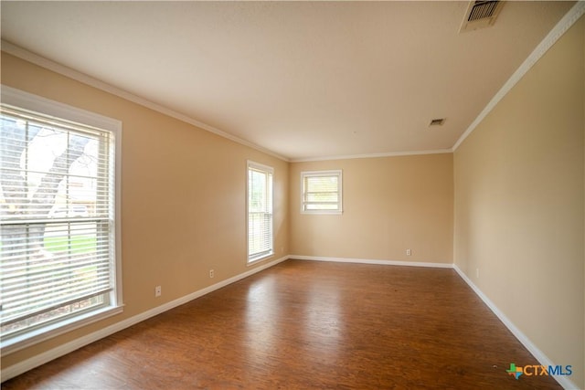 empty room with crown molding and wood-type flooring