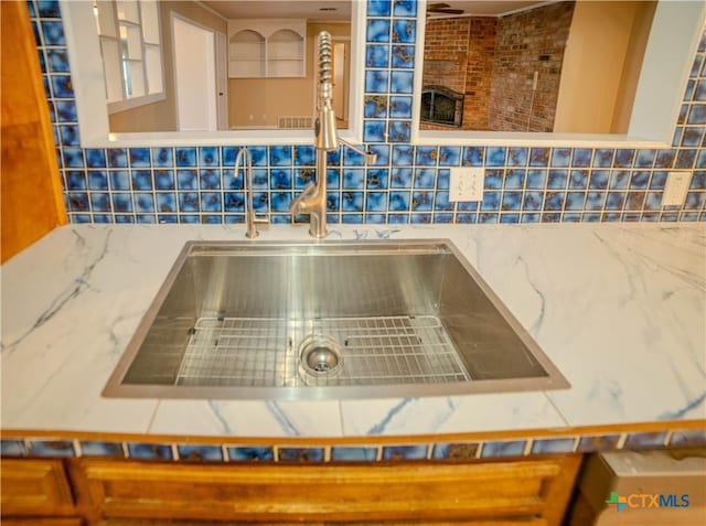 room details featuring sink and decorative backsplash