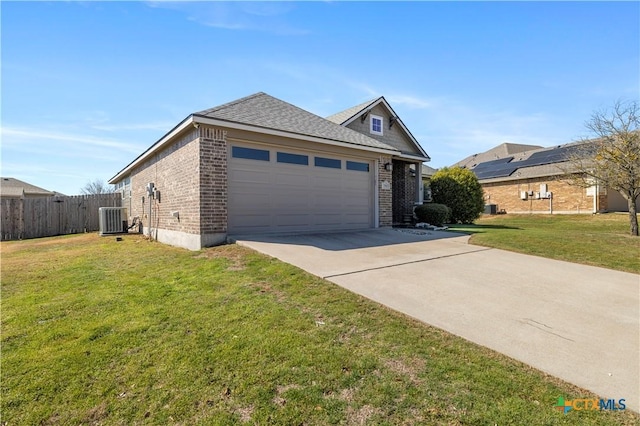 view of front of house featuring brick siding, concrete driveway, central AC, fence, and a front lawn