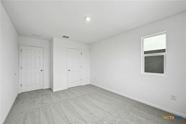 unfurnished bedroom featuring light colored carpet