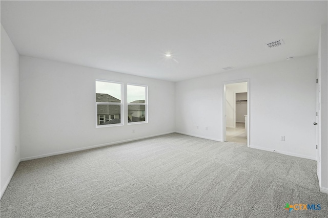 empty room featuring light colored carpet