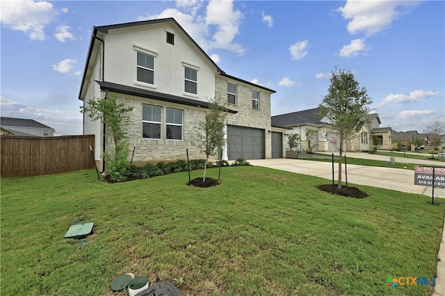 view of front of home with a garage and a front lawn