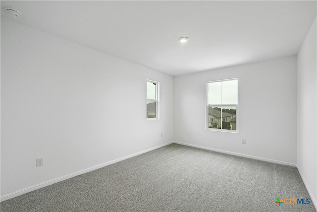 unfurnished room featuring carpet flooring