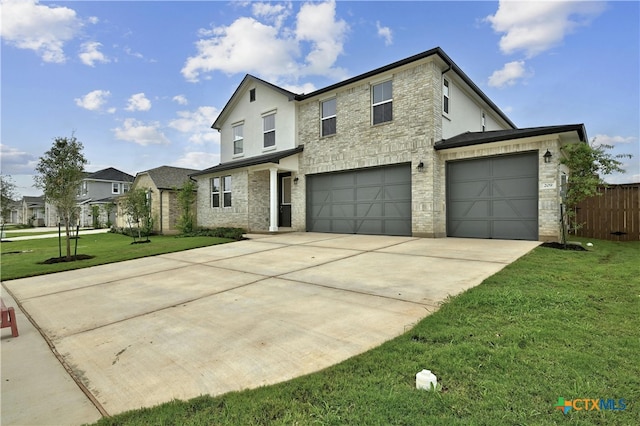 view of front property featuring a garage and a front lawn