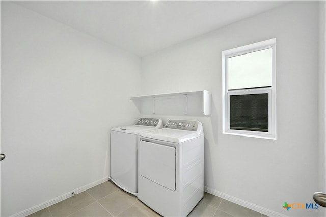 laundry area with washing machine and dryer and light tile patterned flooring