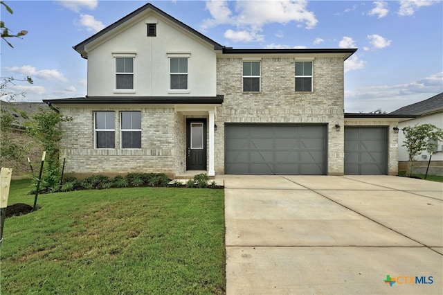 front facade featuring a garage and a front lawn