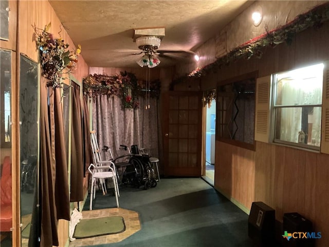 404 Svoboda St, Yoakum, TX 77995 - miscellaneous room with a ceiling fan and wooden walls