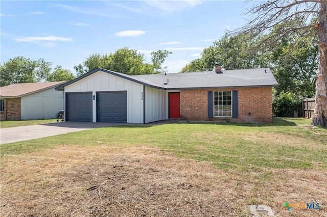 ranch-style house featuring a garage and a front lawn