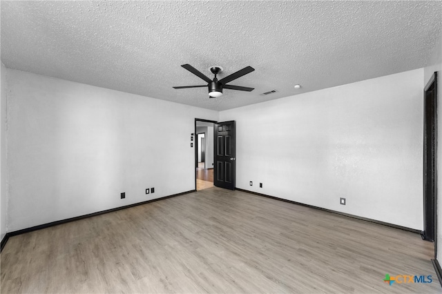 unfurnished room with light hardwood / wood-style flooring, a textured ceiling, and ceiling fan