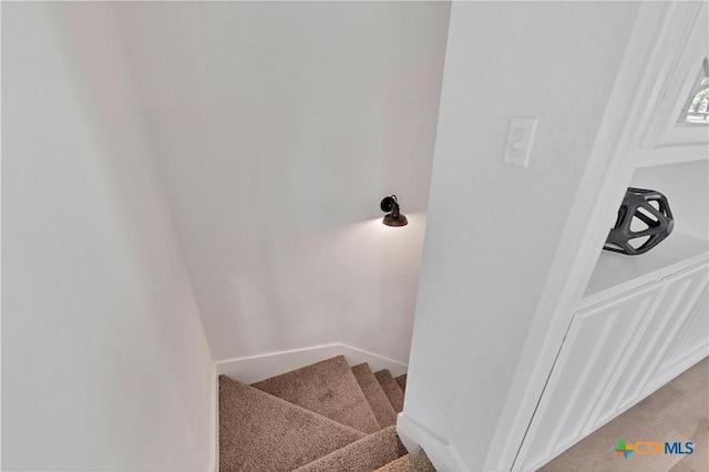 staircase with carpet flooring and baseboards