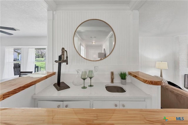 bathroom with a sink, ceiling fan, and a fireplace