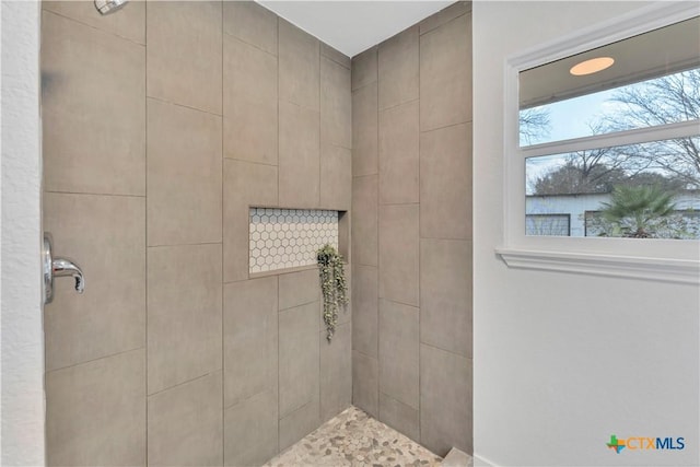 bathroom with a tile shower