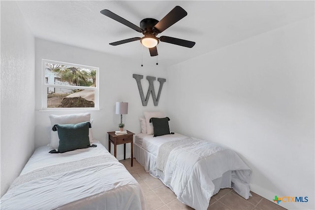 bedroom featuring light tile patterned floors and a ceiling fan