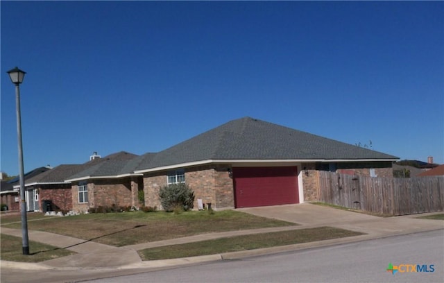 view of front of property with a front yard and a garage