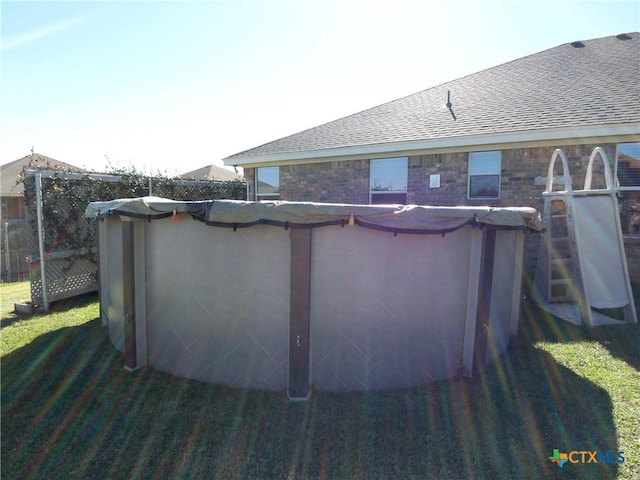 view of swimming pool with a lawn