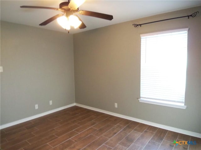 spare room featuring ceiling fan and dark wood-type flooring