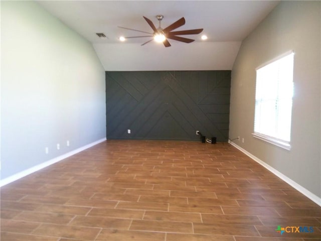 spare room with hardwood / wood-style floors, ceiling fan, and lofted ceiling