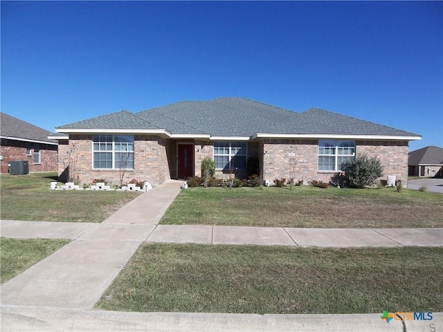 view of front of property featuring central air condition unit and a front lawn