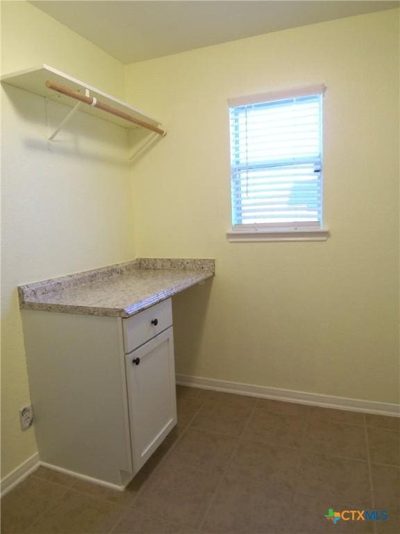 laundry area featuring dark tile patterned floors