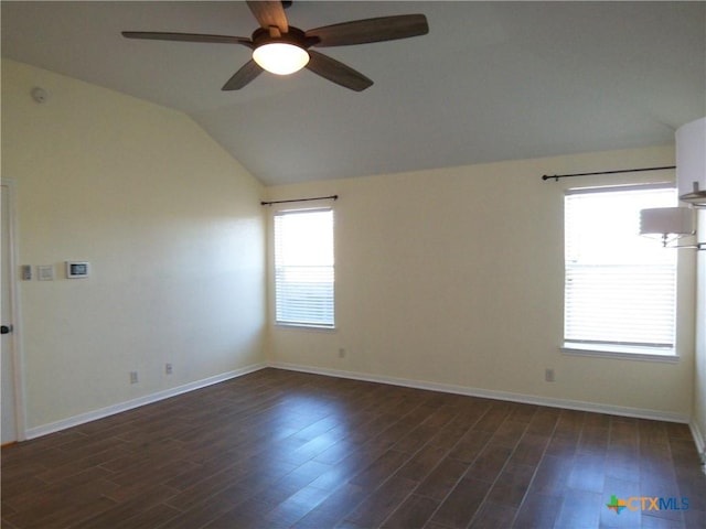 unfurnished room with ceiling fan, dark wood-type flooring, and vaulted ceiling