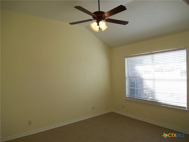 empty room featuring ceiling fan and lofted ceiling