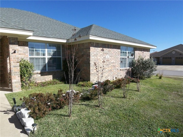 view of side of home with a lawn