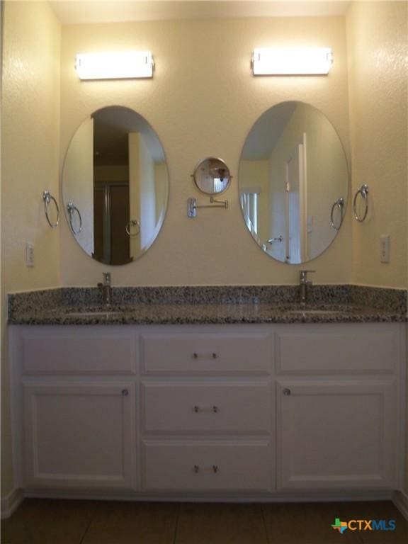 bathroom featuring tile patterned floors and vanity