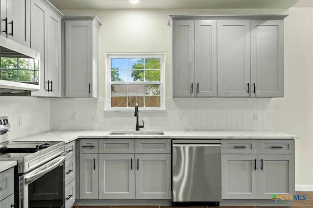 kitchen with gray cabinetry, sink, and appliances with stainless steel finishes